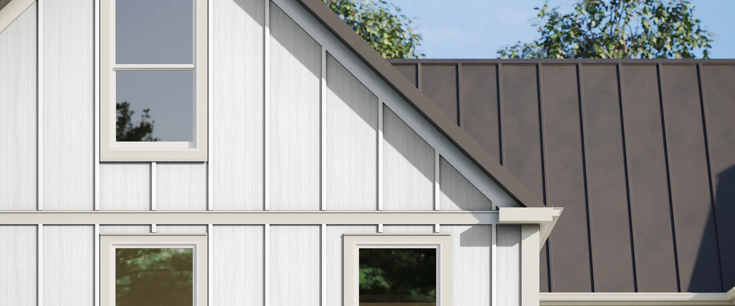 White Hardie Panel vertical siding in Select Cedarmill with batten boards on a farmhouse gable, below a dark standing seam metal roof