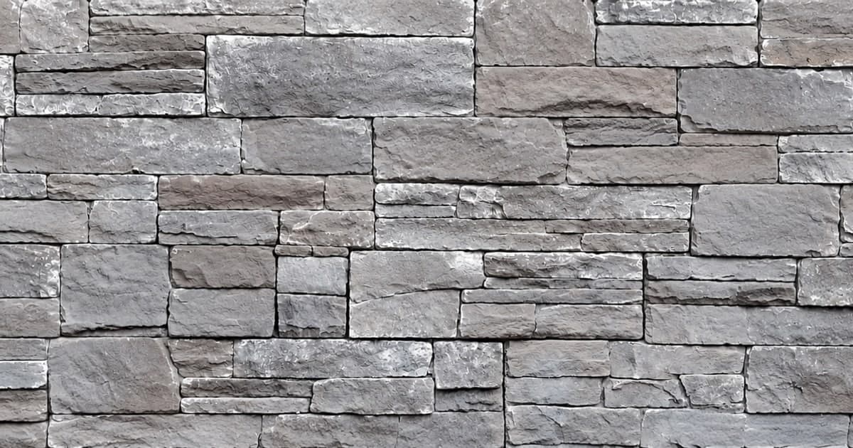 STONEfaçade® architectural stone cladding installed on a residential home exterior — stacked stone veneer